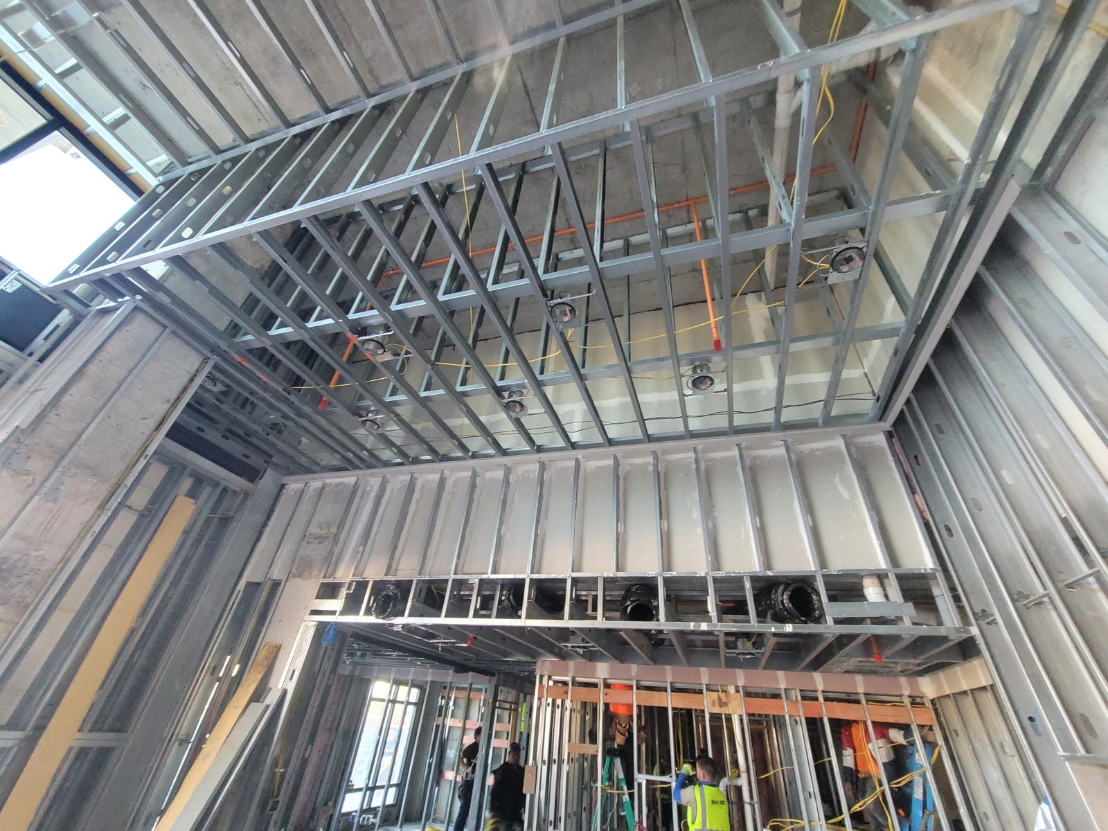 Metal stud framing and ceiling grid installed by Drywall Supreme